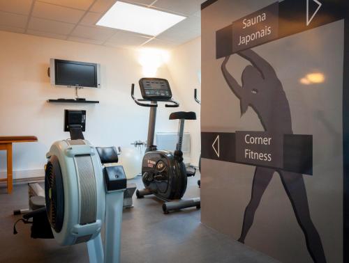 a room with a gym with a sign that reads cancer fitness at Best Western Plus Hôtel Vannes Centre Ville in Vannes