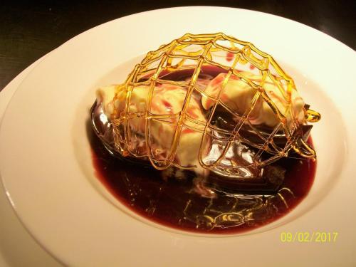 a chocolate dessert on a white plate with sauce at Chapel House in Atherstone