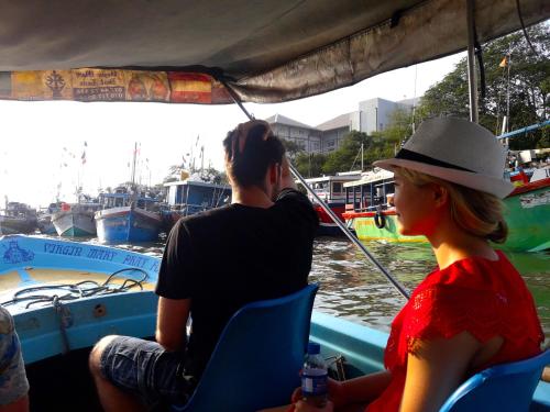 a man and woman on a boat in the water at Nico Lagoon Hotel in Negombo