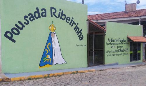 a store with a sign on the side of a building at Pousada Ribeirinha in Aparecida