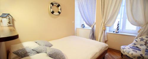a small bedroom with a bed and a chair at Hostellerie de Genève in Vevey