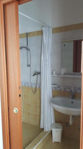 a bathroom with a shower and a sink at Trattoria Bar Pace in Re