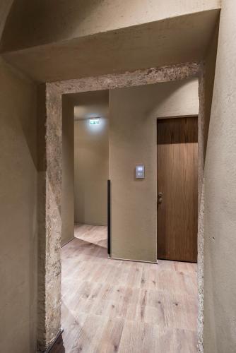 an empty room with a door and a wooden floor at Hotel dei Barbieri in Rome