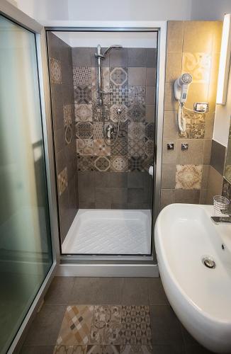 a bathroom with a shower and a sink at Magione del Re in Catania