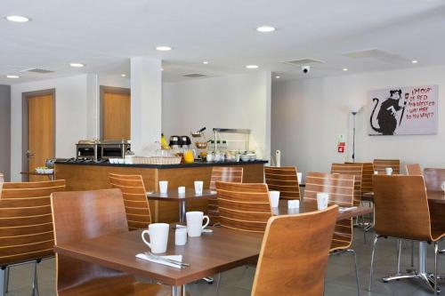 a dining room with wooden tables and chairs at Britannia Study Hotel in Brighton & Hove
