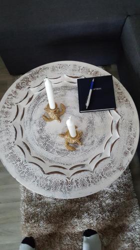a table with two candles and a book on it at Joastorps Bed & Breakfast in Ullared