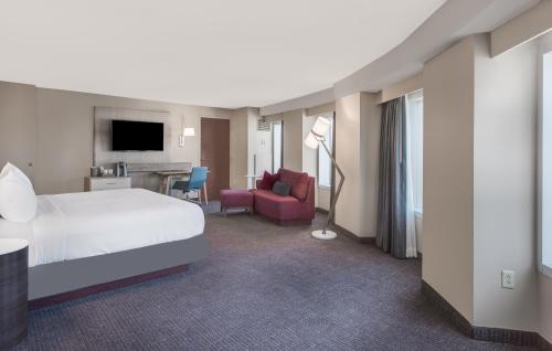 a hotel room with a bed and a living room at Crowne Plaza Cleveland at Playhouse Square, an IHG Hotel in Cleveland