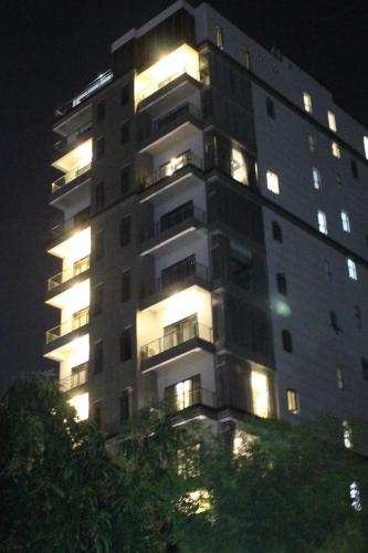 a tall building with its lights on at night at Malis the Residence in Phnom Penh