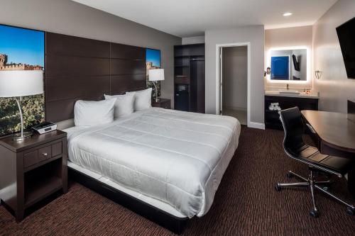 a hotel room with a large bed and a desk at Vallejo Inn in Vallejo