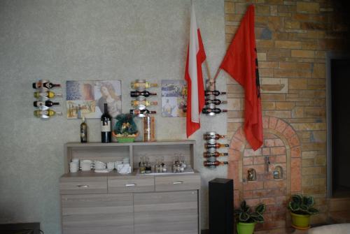 a room with two red flags and a fireplace at Olive Tree in Sarandë