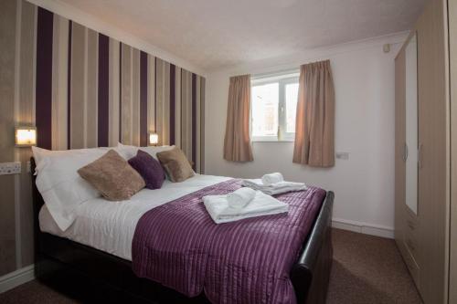a bedroom with a bed with towels on it at Lovely Sea Front House in Cleethorpes - sleeps 6 in Cleethorpes