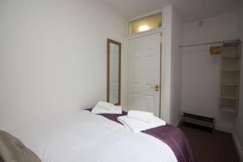 a bedroom with a bed with two towels on it at Lovely Sea Front House in Cleethorpes on Beachfront sleeps up-to 6 in Cleethorpes