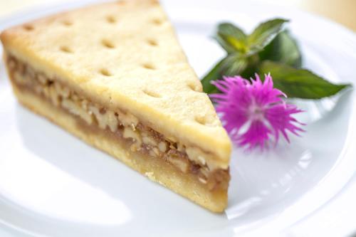 a white plate with a piece of cake and a flower at Hotel Seebüel in Davos