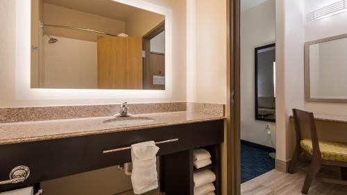 a bathroom with a sink and a mirror at Best Western PLUS Tulsa Inn & Suites in Tulsa