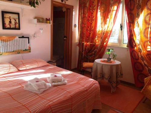 a bedroom with a bed with towels on it at B&B Magna Grecia in Crotone