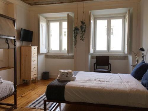 Кровать или кровати в номере De Pedra e Sal Hostel & Suites