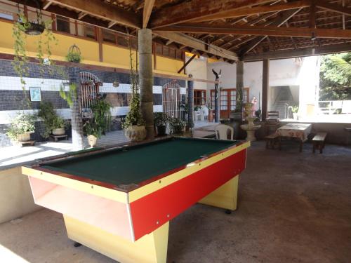 a pool table in the middle of a room at Pousada Terra Nossa in Santa Maria