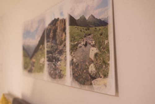 a group of pictures hanging on a wall at Gästehaus Zwischenberger in Obervellach