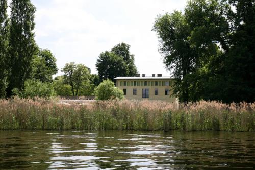 a building next to a body of water at Ferienhaus Caputh in Caputh