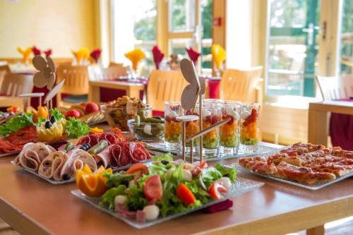 a table with many different types of food on it at Evasion Tonique in Villers-le-Lac