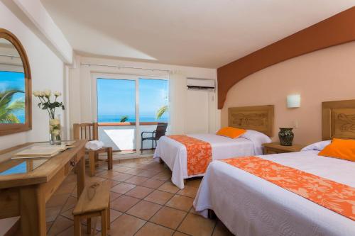 Postel nebo postele na pokoji v ubytování Hotel El Pescador