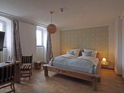 a bedroom with a bed and a desk and a chair at Schloss Spangenberg in Spangenberg