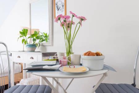 a table with a plate of food and flowers on it at Room in Oss in Oss