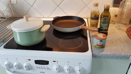 a pot on a stove with a pan on it at The Viking Country Club in Hjalteyri