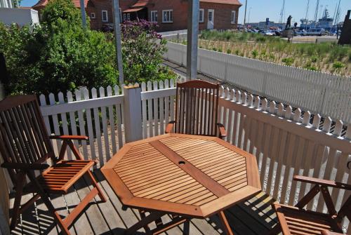 two chairs and a wooden table on a deck at Skagen Room in Skagen