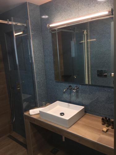 a bathroom with a sink and a shower and a mirror at 360Degrees Pop Art Hotel in Athens