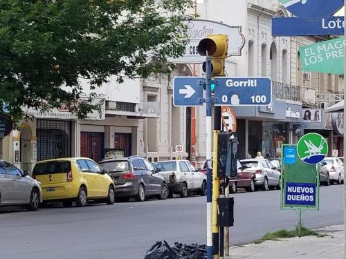 a street sign with cars parked on a city street at M&A Apartamentos Temporales in Bahía Blanca