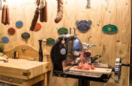 a kitchen with a meat machine on a cutting board at Au Cheval Blanc in Waimes