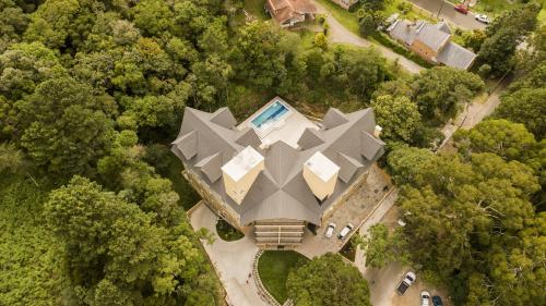 an aerial view of a house with a pyramid shaped roof at Sky Serra Hotel in Gramado