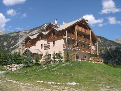 a house on top of a hill in the mountains at Hôtel L'Echaillon in Névache