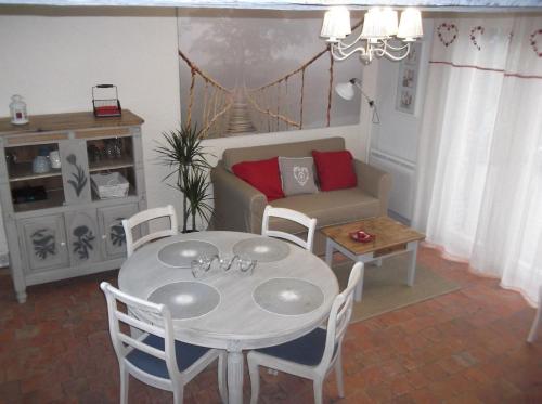 a living room with a table and a couch at La Reine des Prés in Marly-Gomont
