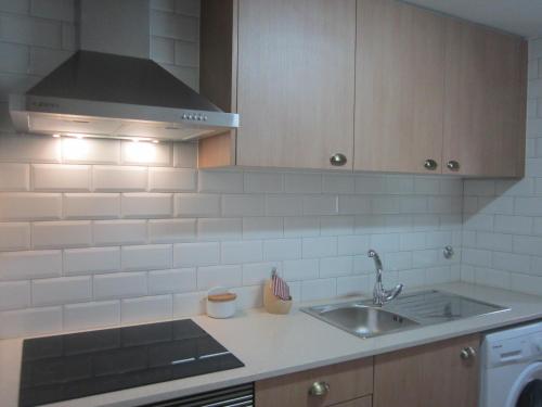 a kitchen with a sink and a stove at Casa Zé Bonito I in Cascais