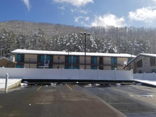 a parking lot in front of a building with snow at Blue Sky Inn- Complimentary Happy Hour Th-Sun, Veteran owned, Full Breakfast, Best green space, 1 mile from Blue Ridge, Fire Pit in Blue Ridge