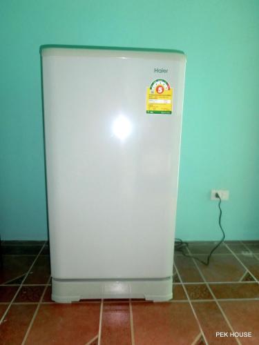 a white refrigerator with a sticker on the side of it at Pek House in Phuket Town