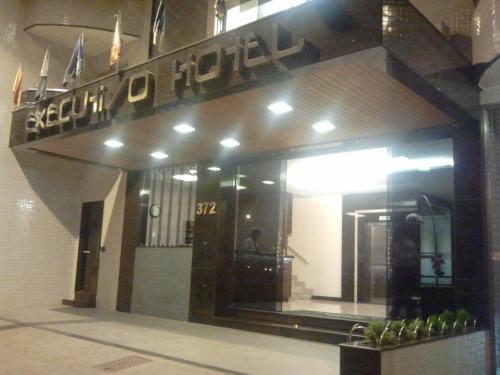 a building with a sign for a hotel at Executivo Hotel in Montes Claros