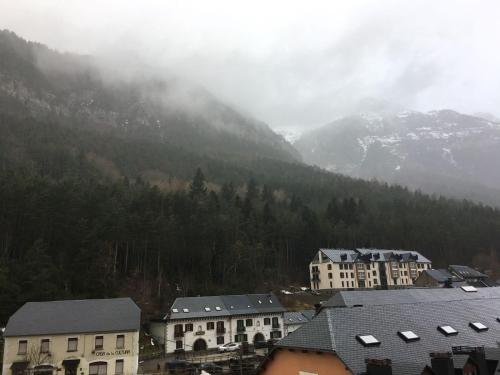 a group of buildings in front of a mountain at Magnífico Ático Duplex con vistas a la montaña in Canfranc-Estación