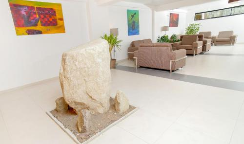 a lobby with a large rock in the middle of a room at Golden Sunrise Machupicchu in Machu Picchu