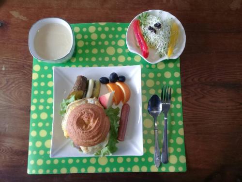 a plate of food with a sandwich on a table at One Piece B&B in Dongshan