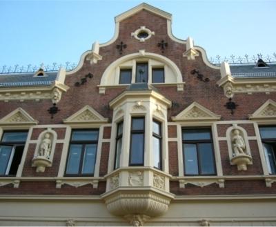 
a large building with a large window at Restaurant & Hotel Wismar in Wismar
