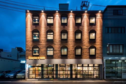 a large brick building with lights on it at Drop Inn Tottori in Tottori