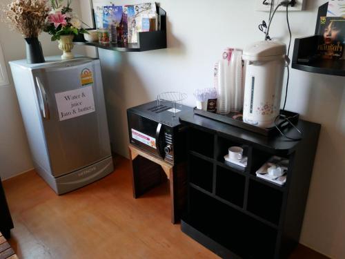 a room with a refrigerator and a table with a blender at Phuket Marine Poshtel - SHA Plus in Chalong 