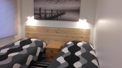 a room with two beds and a picture of a bridge at Haavalehe Summer House in Haapsalu