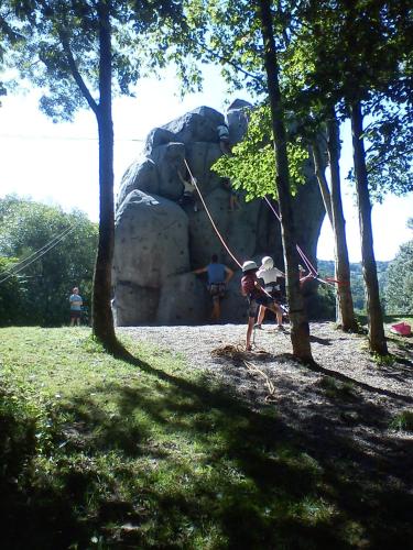 a young child is standing in front of a statue at Camping Base de Loisirs du Lac de la Moselotte in Saulxures-sur-Moselotte