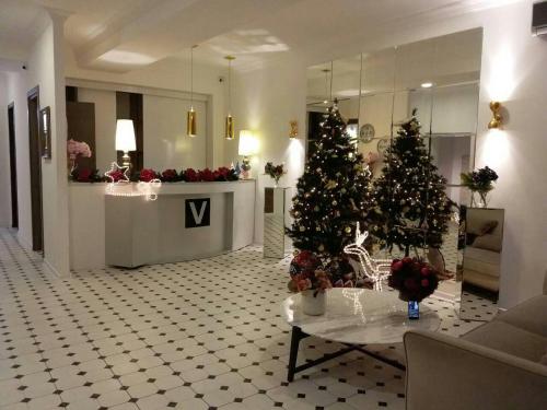 a lobby with two christmas trees in a room at Tbilisi View Hotel in Tbilisi City