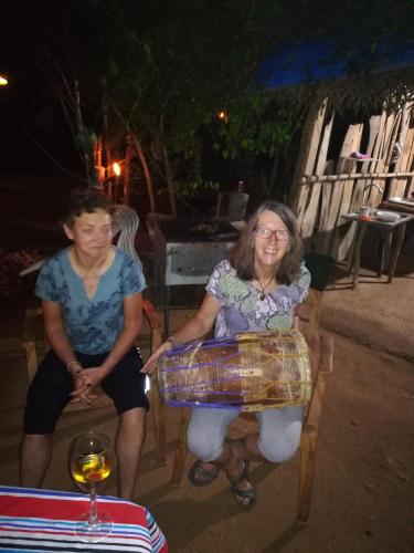 a woman sitting in a chair next to a man at Hidden Jungle Village in Wilpattu