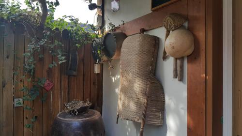 a wall with a bunch of items hanging on it at Hanok Story Guesthouse in Jeonju